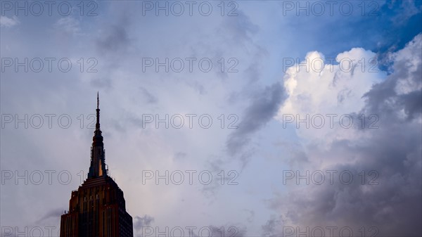 USA, New York, New York City, Empire State Building against clouds.