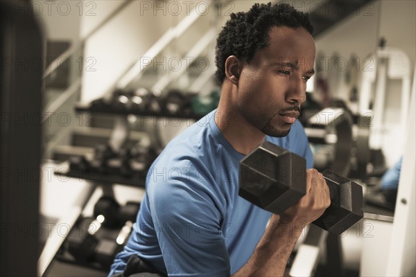 Mid adult man working out in gym.