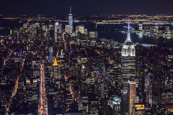 USA, New York, New York City, Manhattan, Aerial view of illuminated skyline at night.