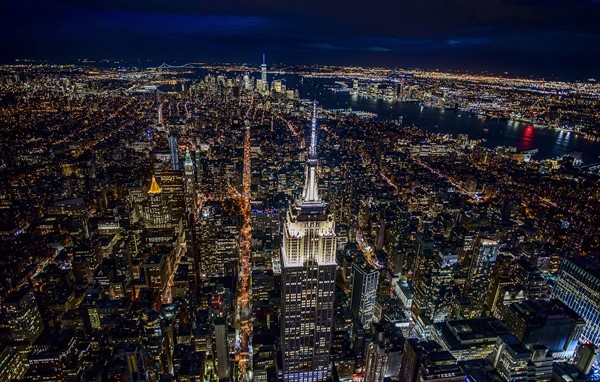 USA, New York, New York City, Manhattan, Aerial view of illuminated skyline at night.