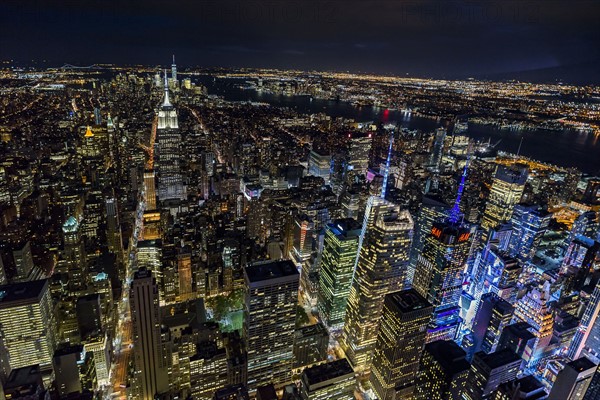 USA, New York, New York City, Manhattan, Aerial view of illuminated skyline at night.