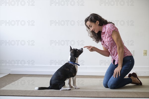 Young woman training her dog.