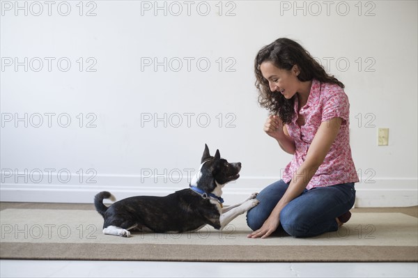 Young woman training her dog.