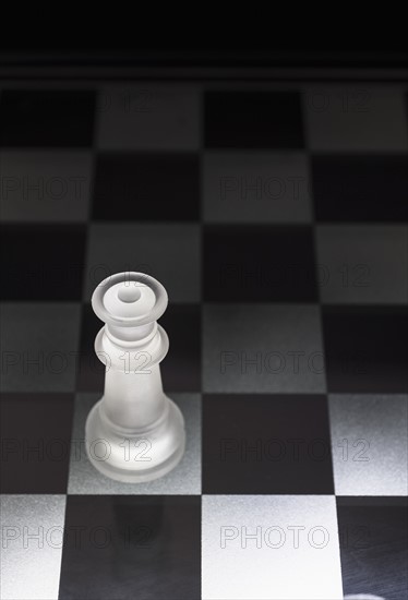 Chess queen on chess board.