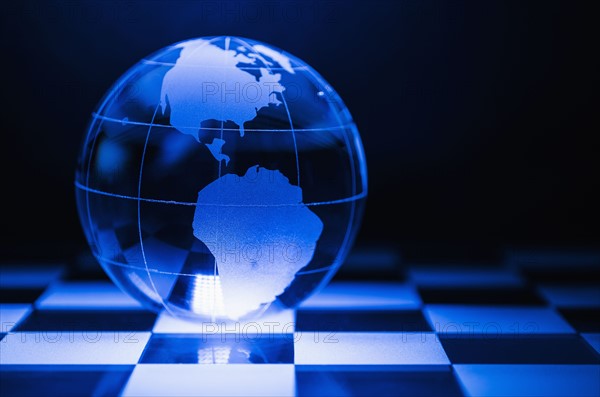 Globe on chess board.