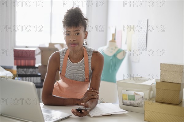 Young fashion designer in home office.