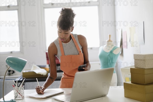 Young fashion designer in home office.