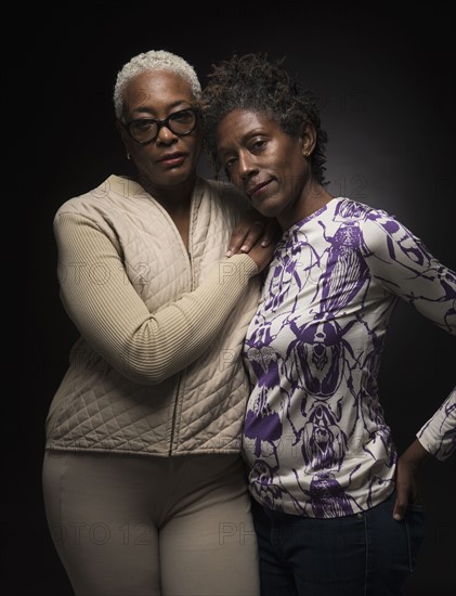 Portrait of two women standing in embrace.