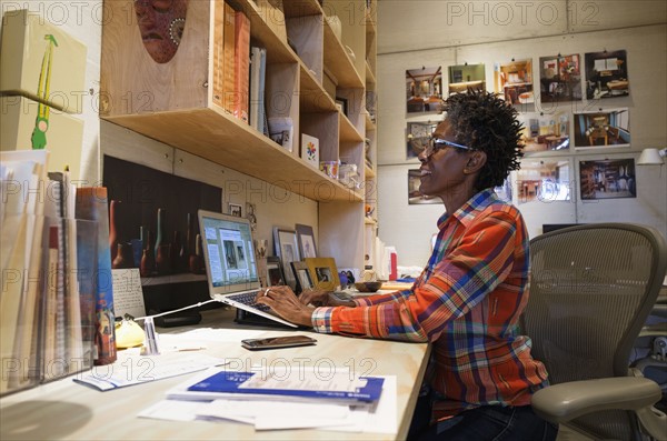 Woman using laptop in office.