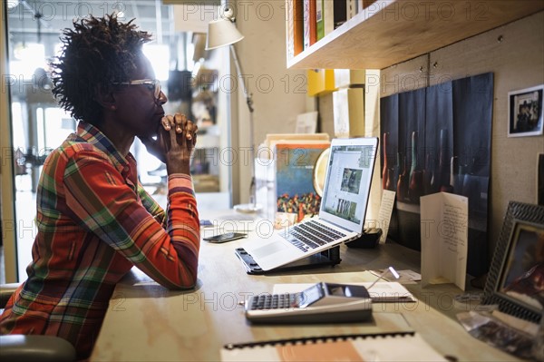 Woman using laptop in office.