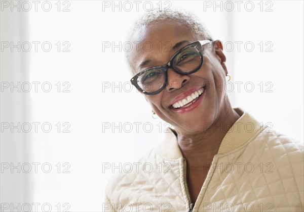 Portrait of smiling woman looking at camera.