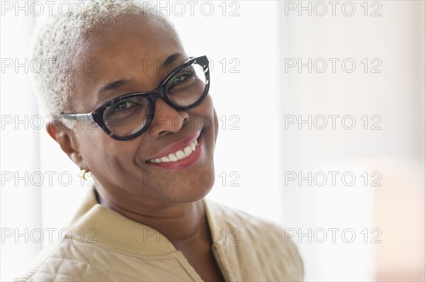 Portrait of smiling woman looking at camera.