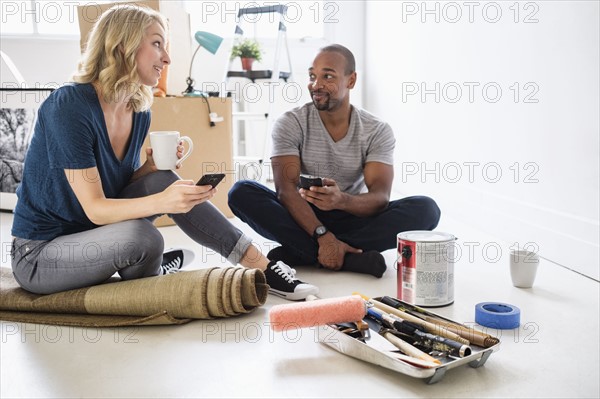 Couple taking break during apartment renovation.