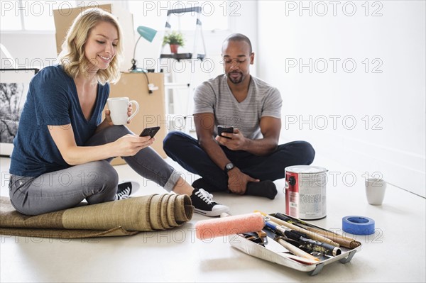 Couple taking break during apartment renovation.