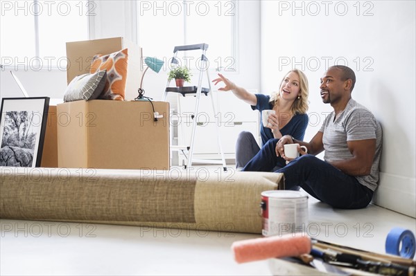 Multi ethnic couple in new apartment.