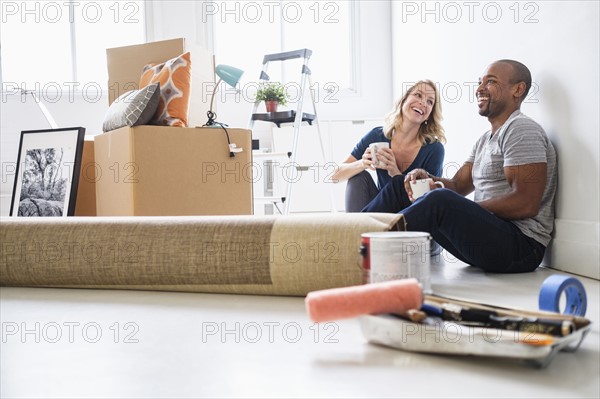 Multi ethnic couple in new apartment.