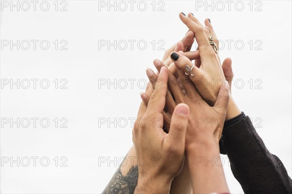 Friends holding their hands together.