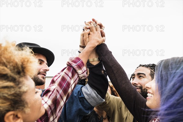 Friends holding their hands together.