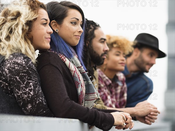 Friends in city looking at view together.