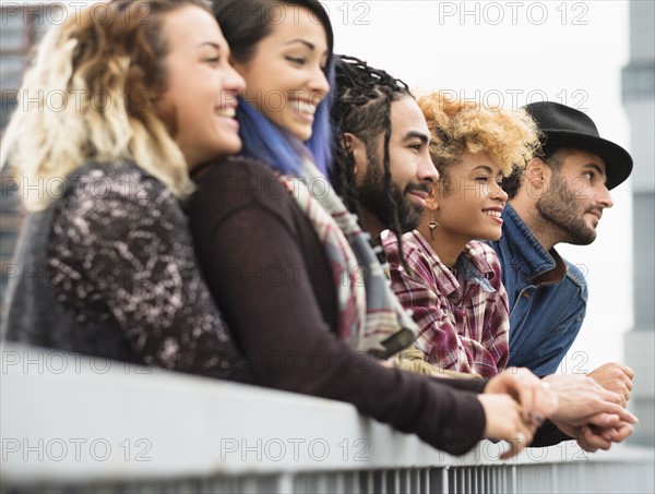 Friends in city looking at view together.