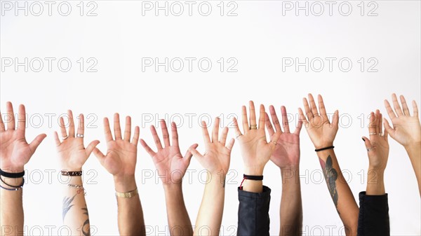 Raised hands against white background.