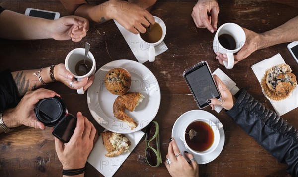 Friends having coffee together in cafe.