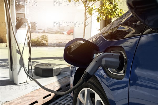 Electric car recharging in charging station.