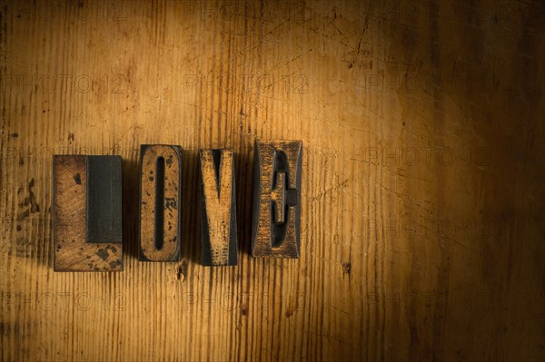 Wooden blocks spelling 'love'.