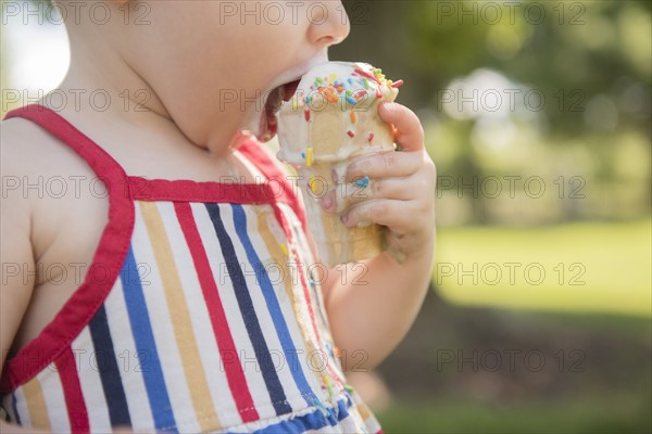 Baby girl (18-23 months) eating ice-cream