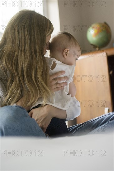 Mother hugging daughter (18-23 months)