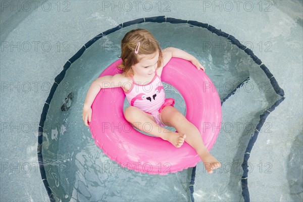 Girl (2-3) on inflatable ring in pool