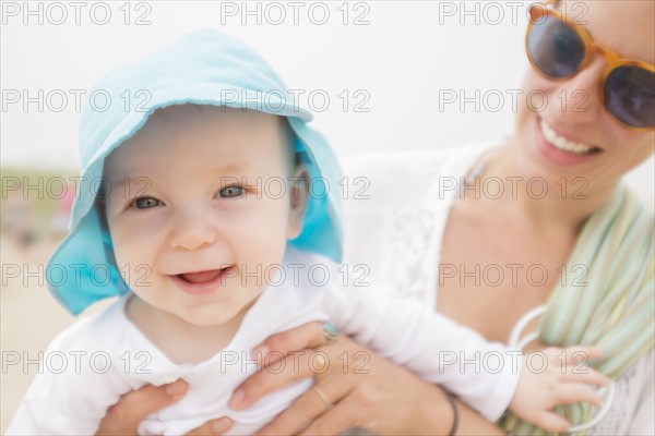 Mother and son (6-11 months) on beach