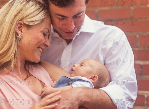 Couple with baby son (0-1 months)