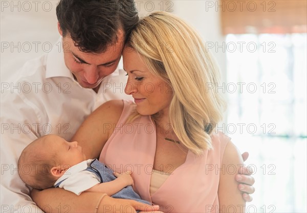 Couple with baby son (0-1 months)