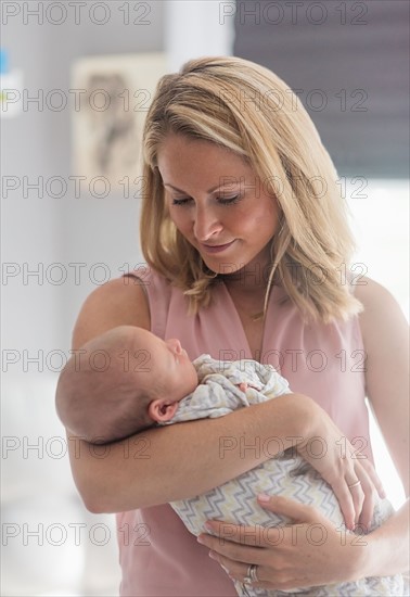 Mother holding baby son (0-1 months)