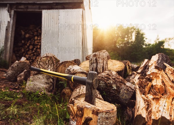 USA, Maine, Knox, Axe beside shed at sunset