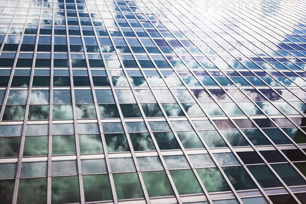 USA, New York State, New York City, Sky reflecting in facade of skyscraper