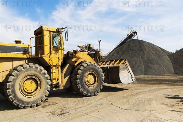 Bulldozer and heap of gravel