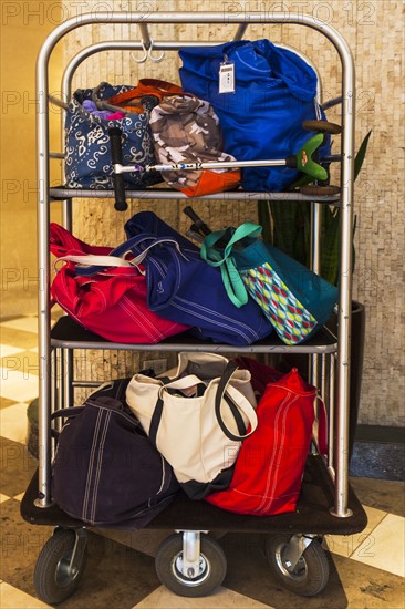 Hotel luggage cart filled with bags