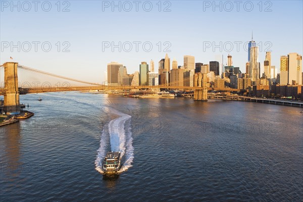 USA, New York State, New York City, Ship on East River with Brooklyn Bridge and city panorama in background