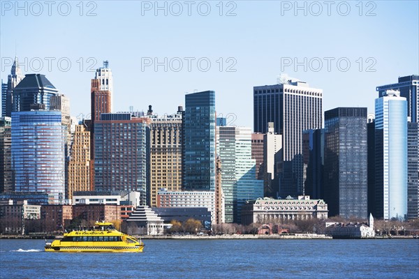 USA, New York State, New York City, Manhattan, City panorama with water taxi passing by
