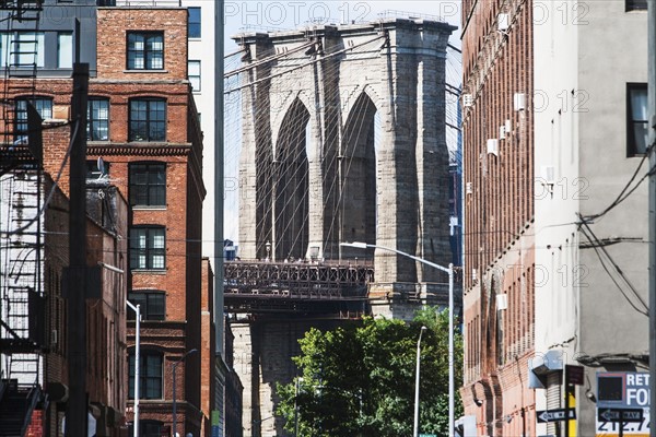 USA, New York State, New York City, Brooklyn Bridge arches seen from between buildings