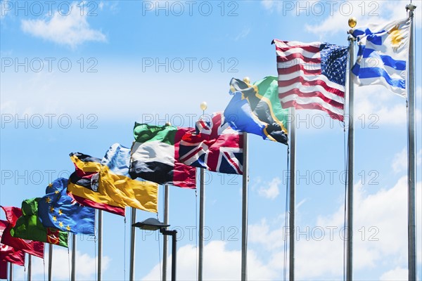 USA, New York State, New York City, Flags fluttering against cloudy sky