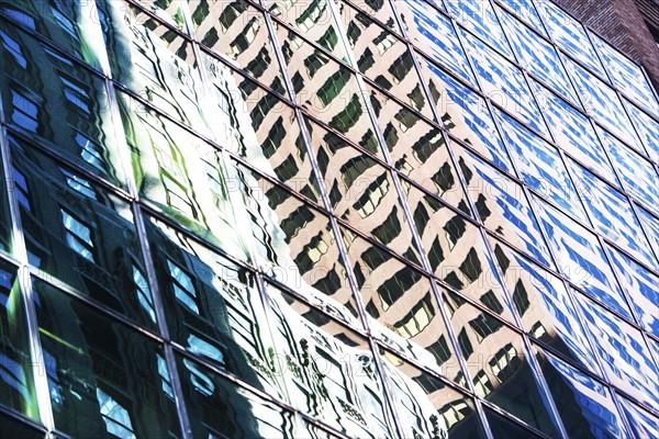 USA, New York City, Glass facade of office building