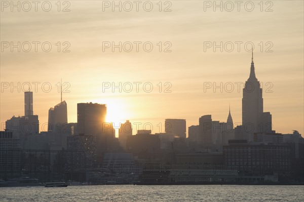 USA, New York, New York City, Sunrise over city