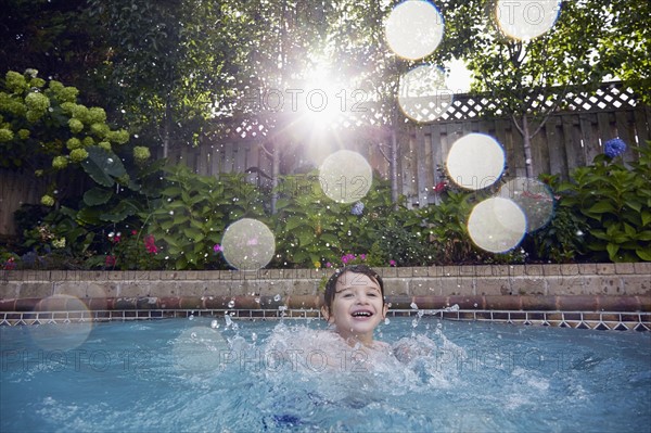 Boy (4-5) playing in pool