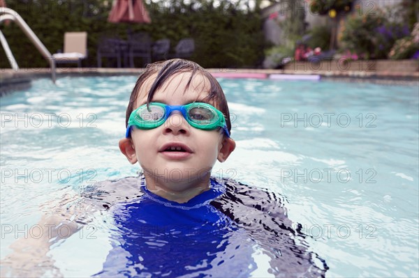 Boy (4-5) playing in pool