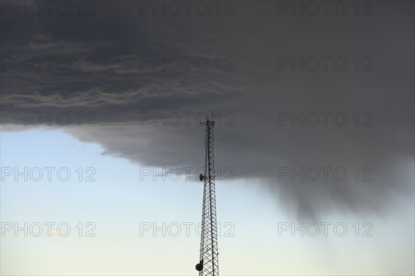 Storm clouds gathering above communications tower