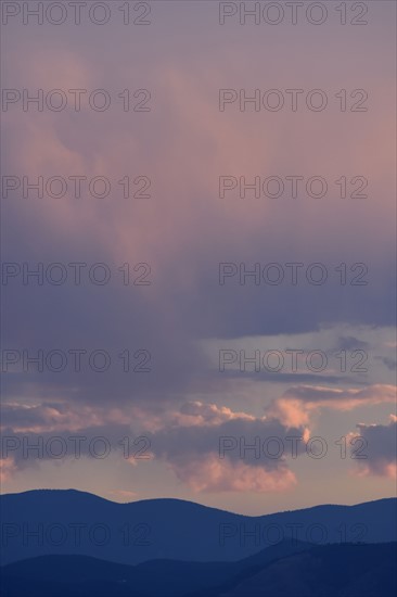 USA, Colorado, Denver, Colorful evening sky over mountain range