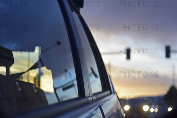 Reflections of city traffic in car's window